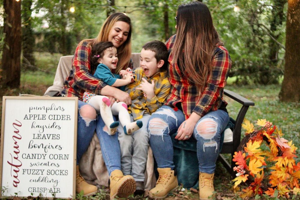 Fall family photo session with seasonal decor and autumn themed props.
