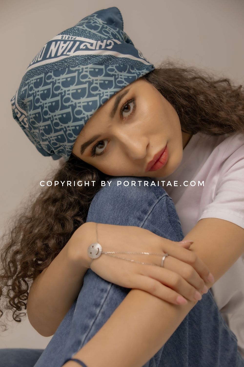 girl with denim pant and white t shirt and dior head scarf posing front of camera