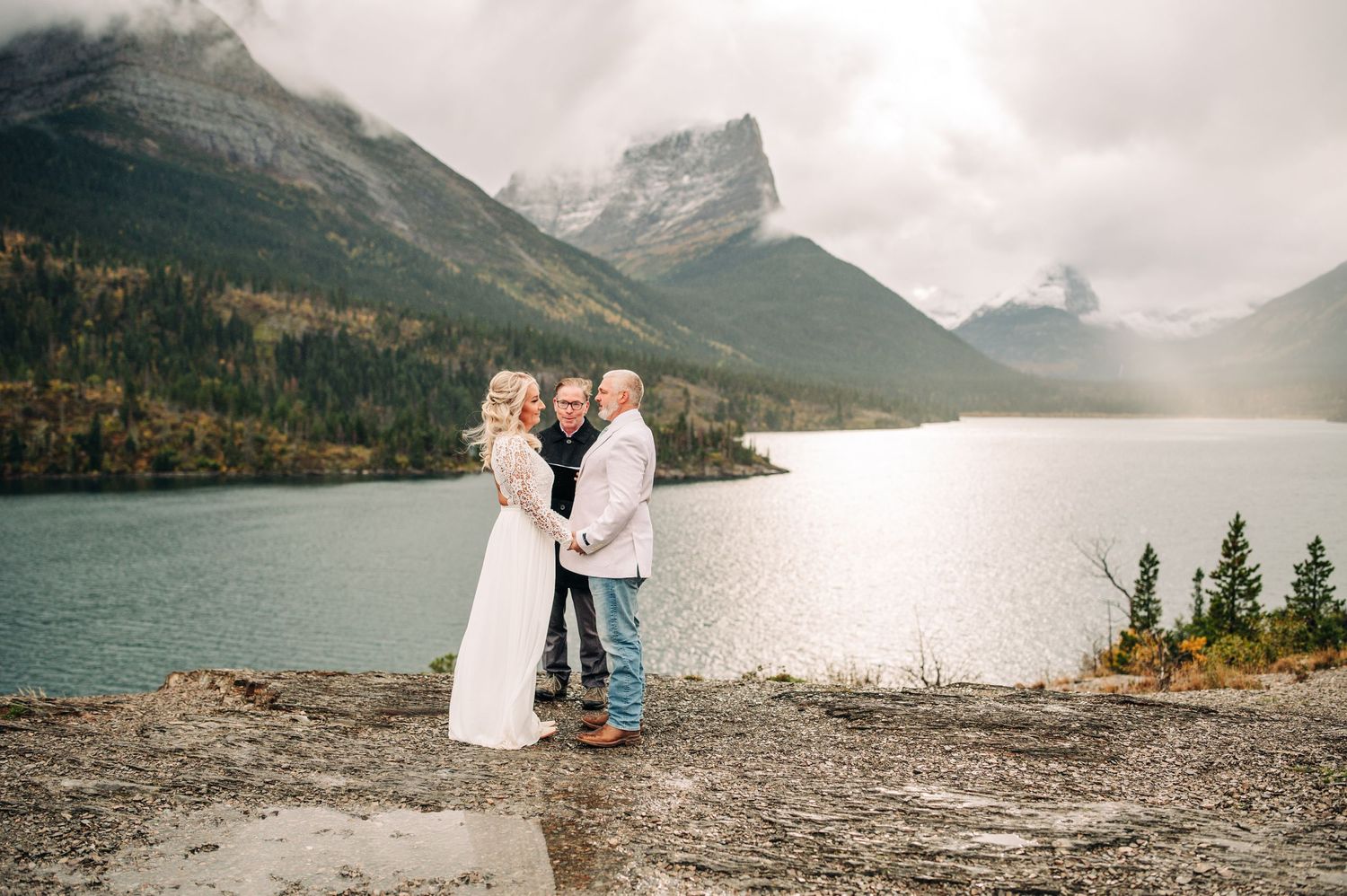 couple getting married at sun point in glacier national park