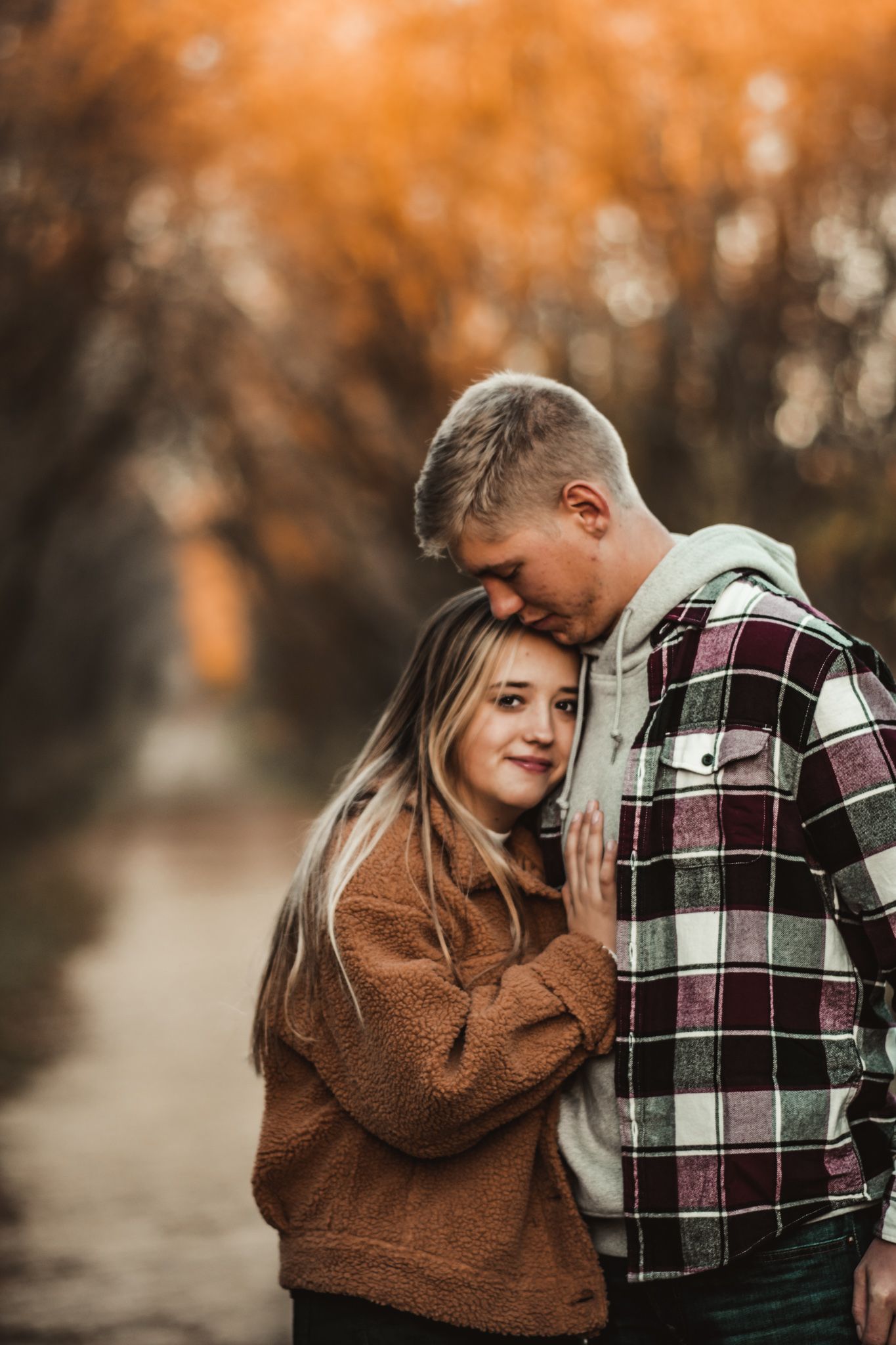 A cozy autumn portrait featuring warm earth tones and plaid flannel clothing.