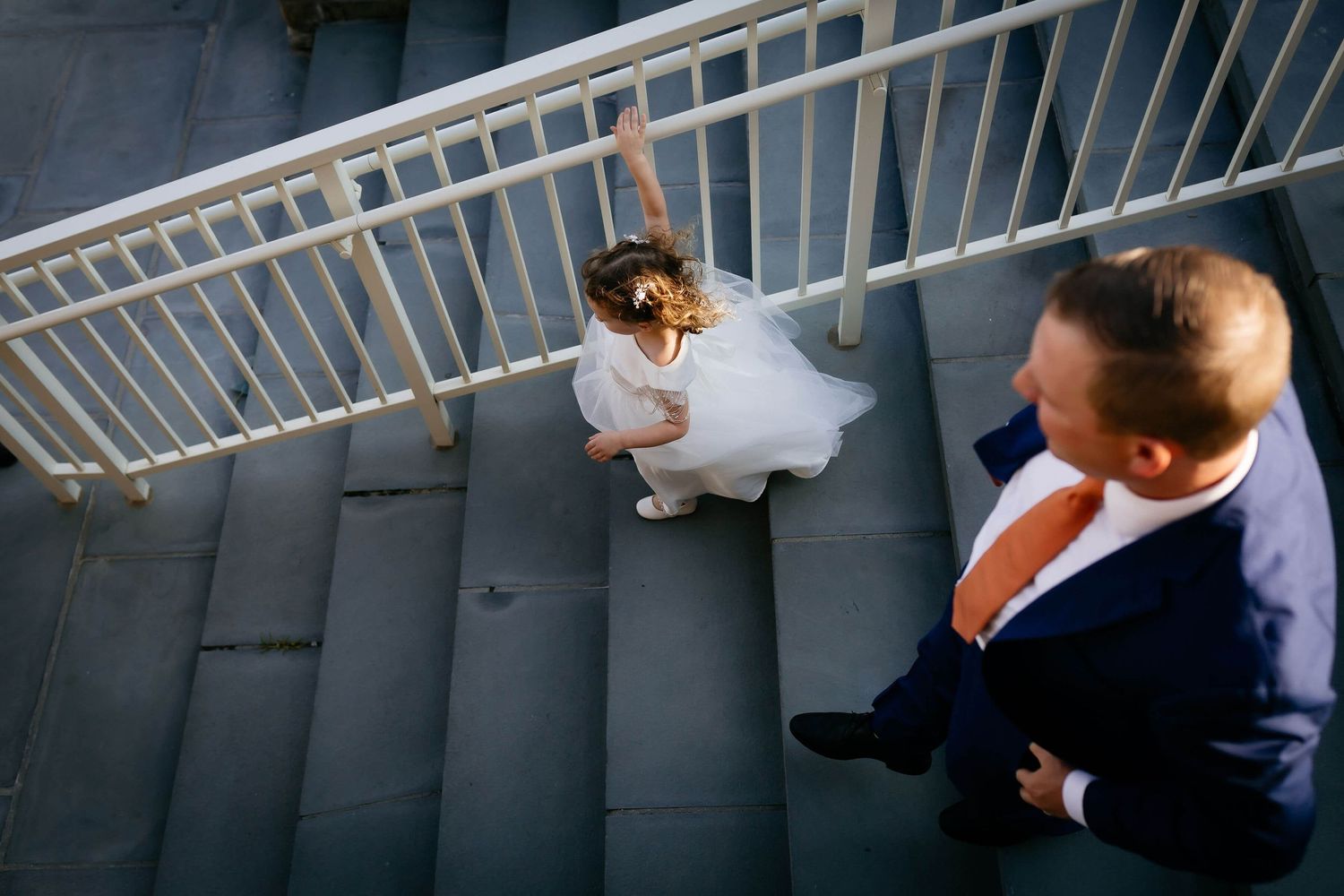 A young flowergirl rushes to the wedding ceremony at Jones Beach NY.