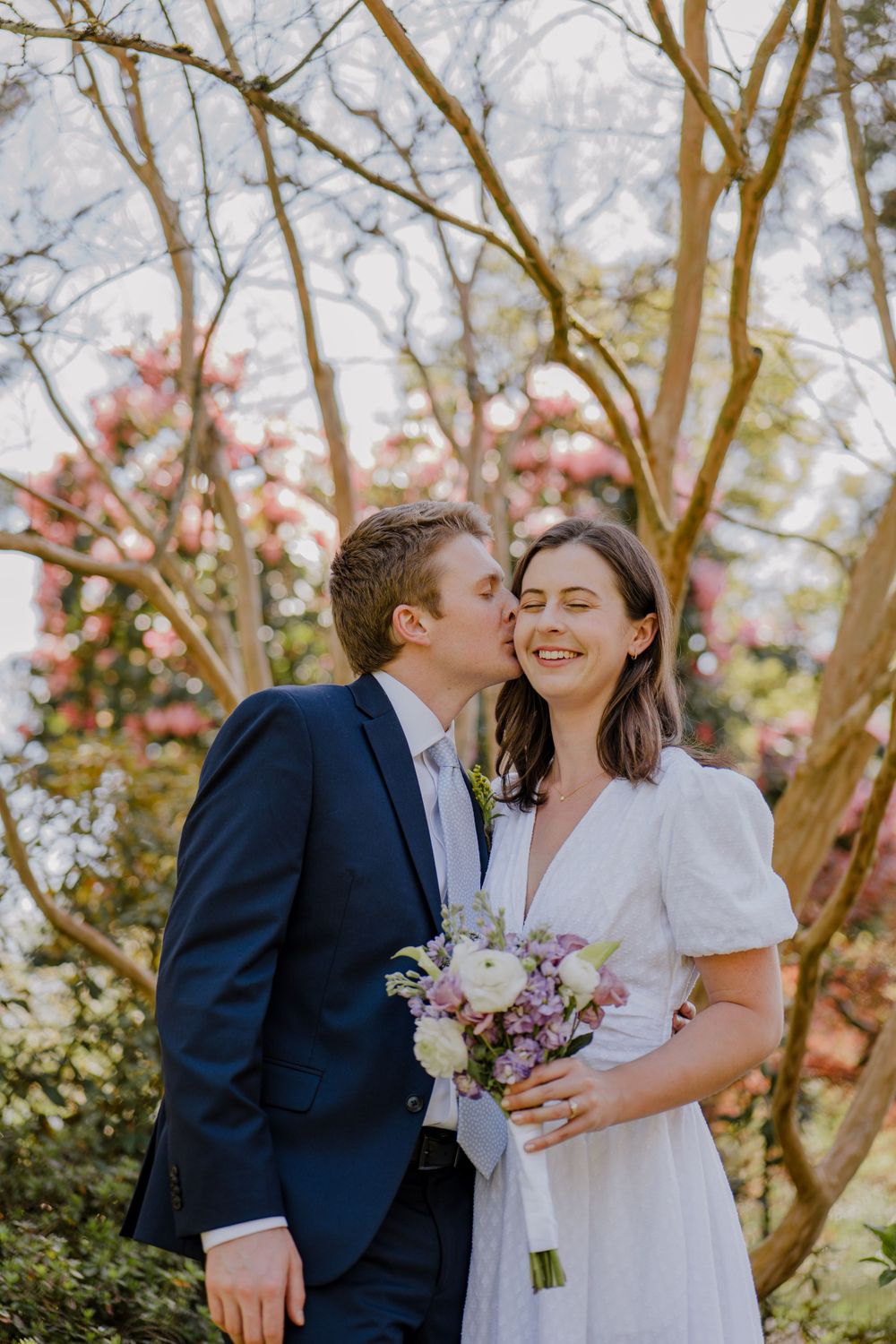Groom kissing bride on the cheek