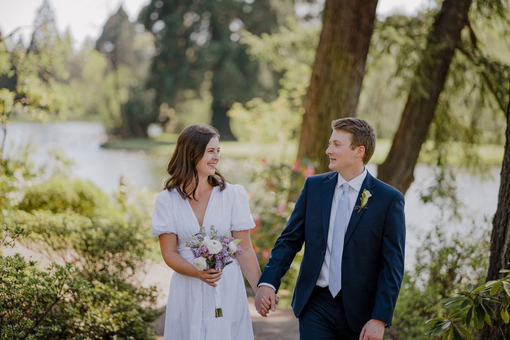 Bride and groom holding hands and smiling at each other