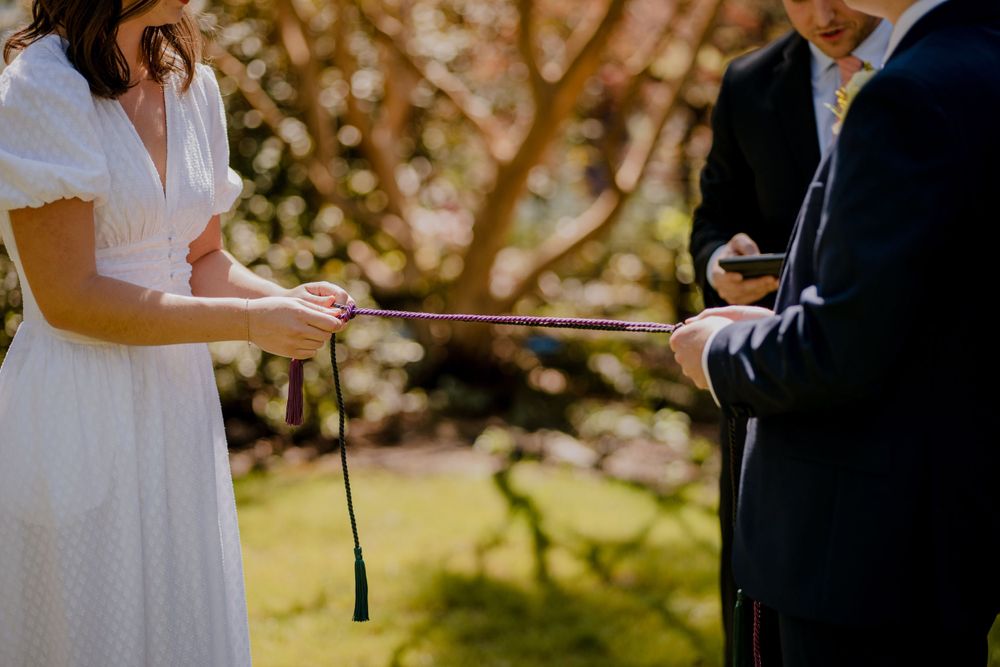 Bride tying rope during ceremony