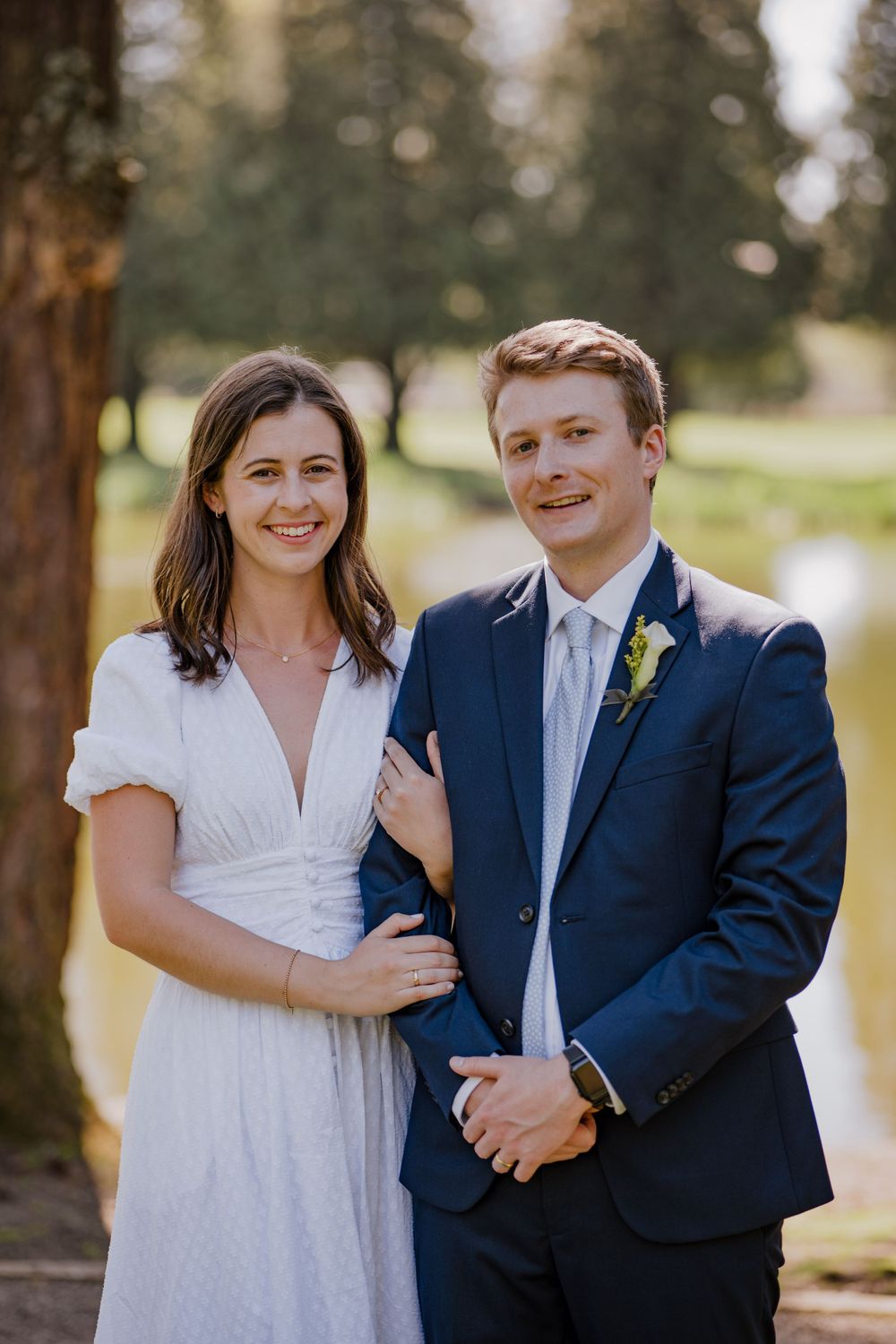 Bride holding grooms arm