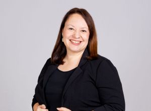 headshot of woman in front of gray backdrop