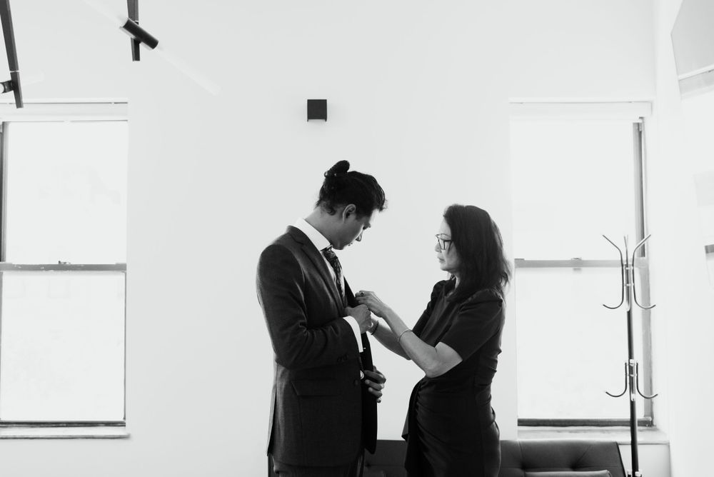 Black and white image of getting ready moments in a bright minimalist room.