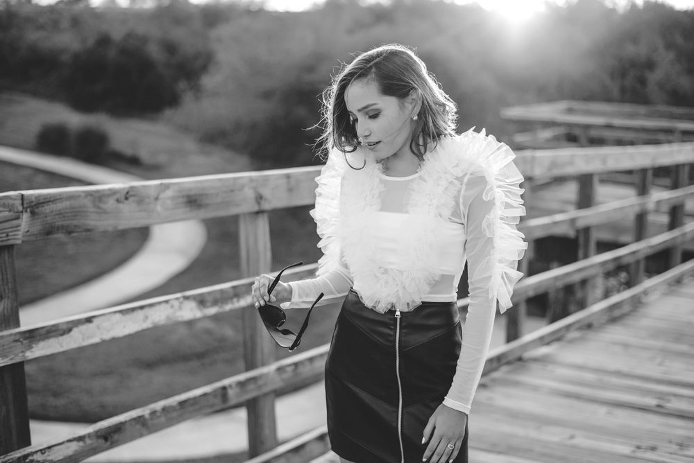 black and white of girl looking down on bridge. Hidalgo pump house. Hidalgo, texas. wedding photography