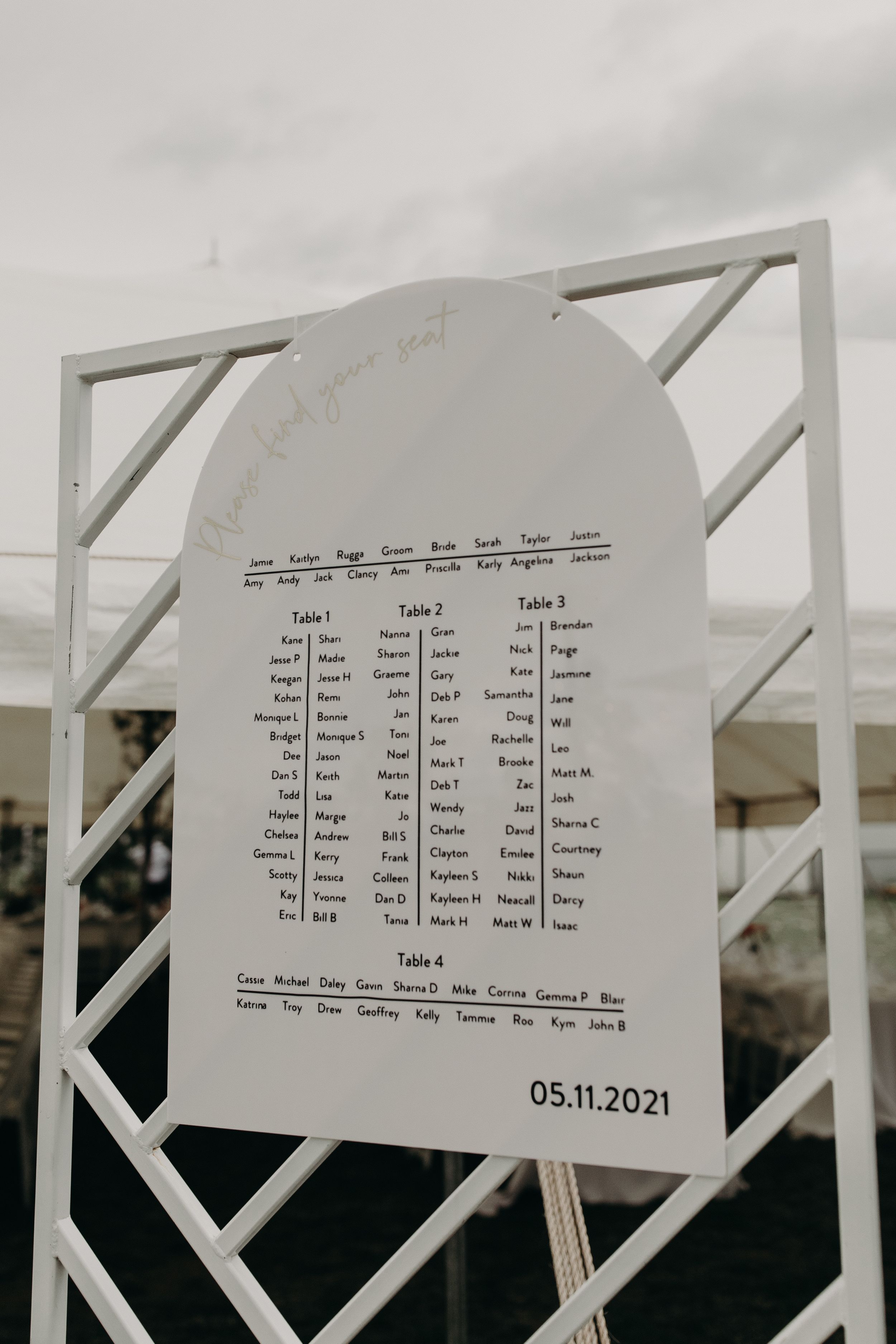 Wedding seating chart displayed on white paper with table assignments dated 05.11.2021.