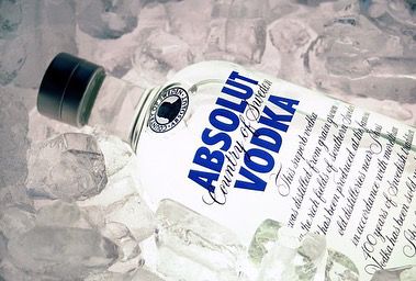 Bottle of Absolut vodka lying on ice cubes.