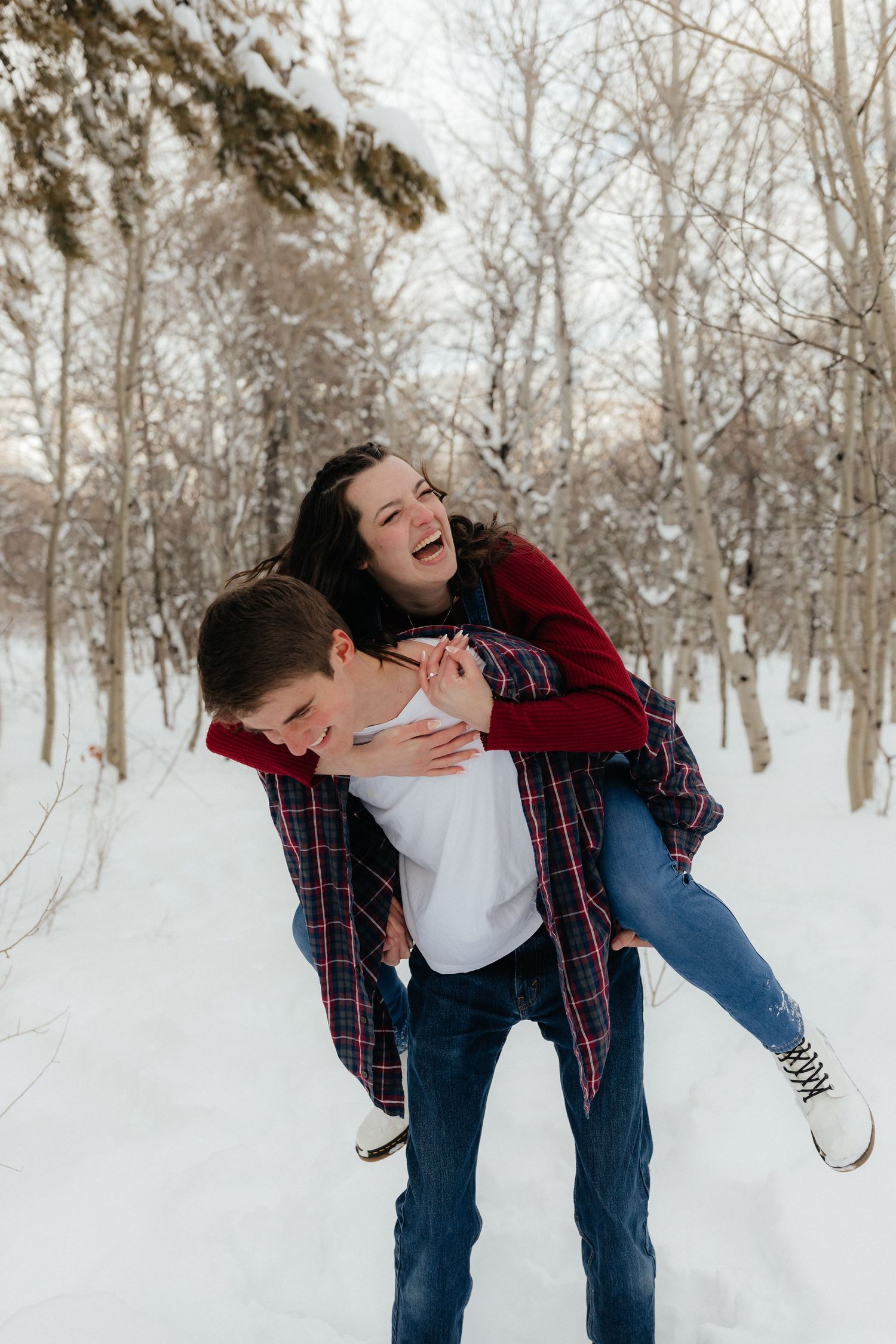 Girl Piggy back on Fiance in Snowy woods