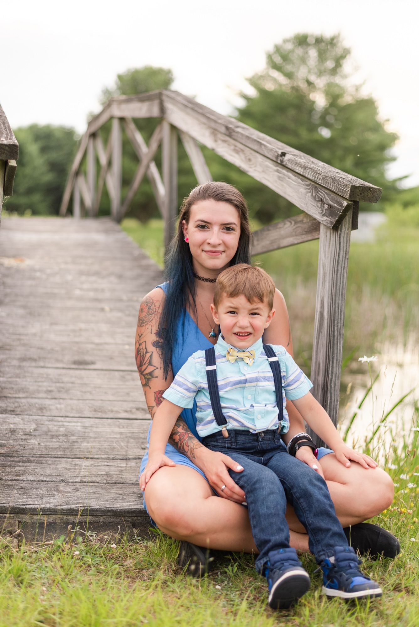 Mother and son sitting on bridge in pond in Clarion Pennsylvania