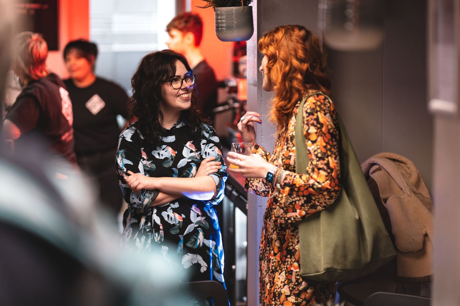 Guests socialising at a corporate evening reception with warm ambient lighting, candid corporate event photography