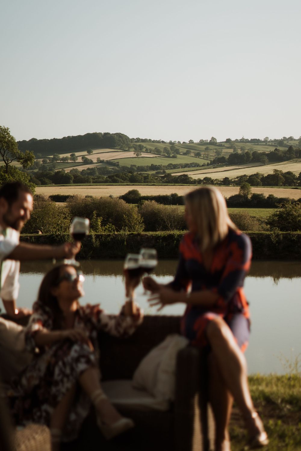 artistic image of wedding guests drinking wine in the countryside