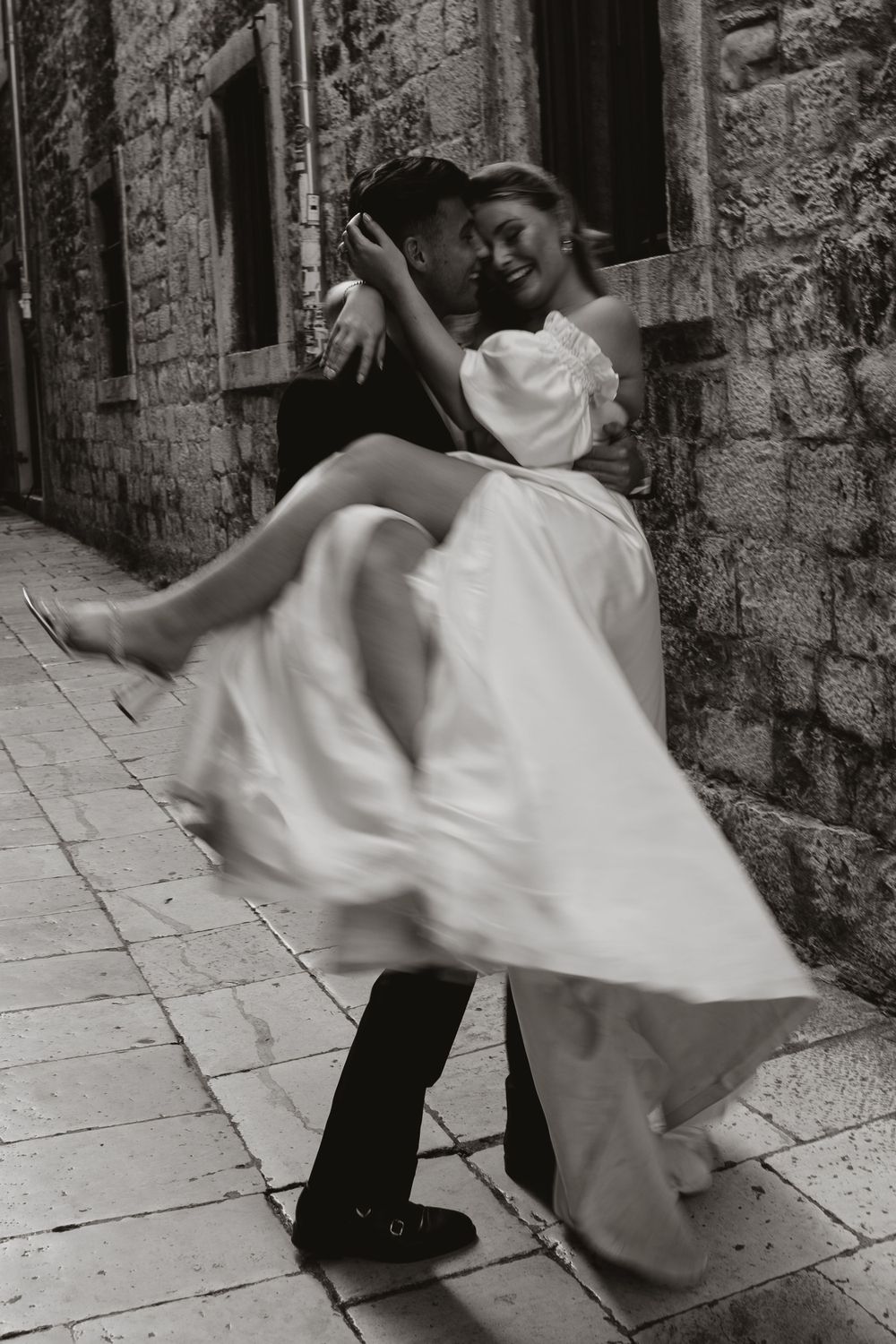 bride and groom spinning around in split, Croatia making the photo artistically blurry