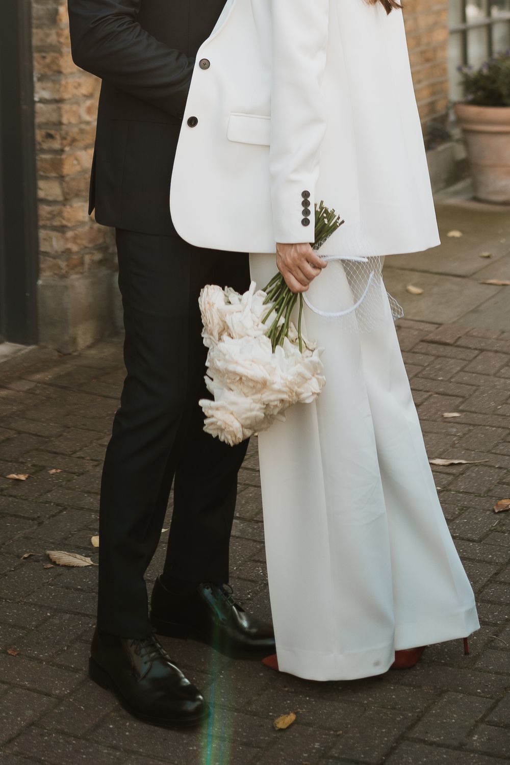 modern bridal suit and white roses
