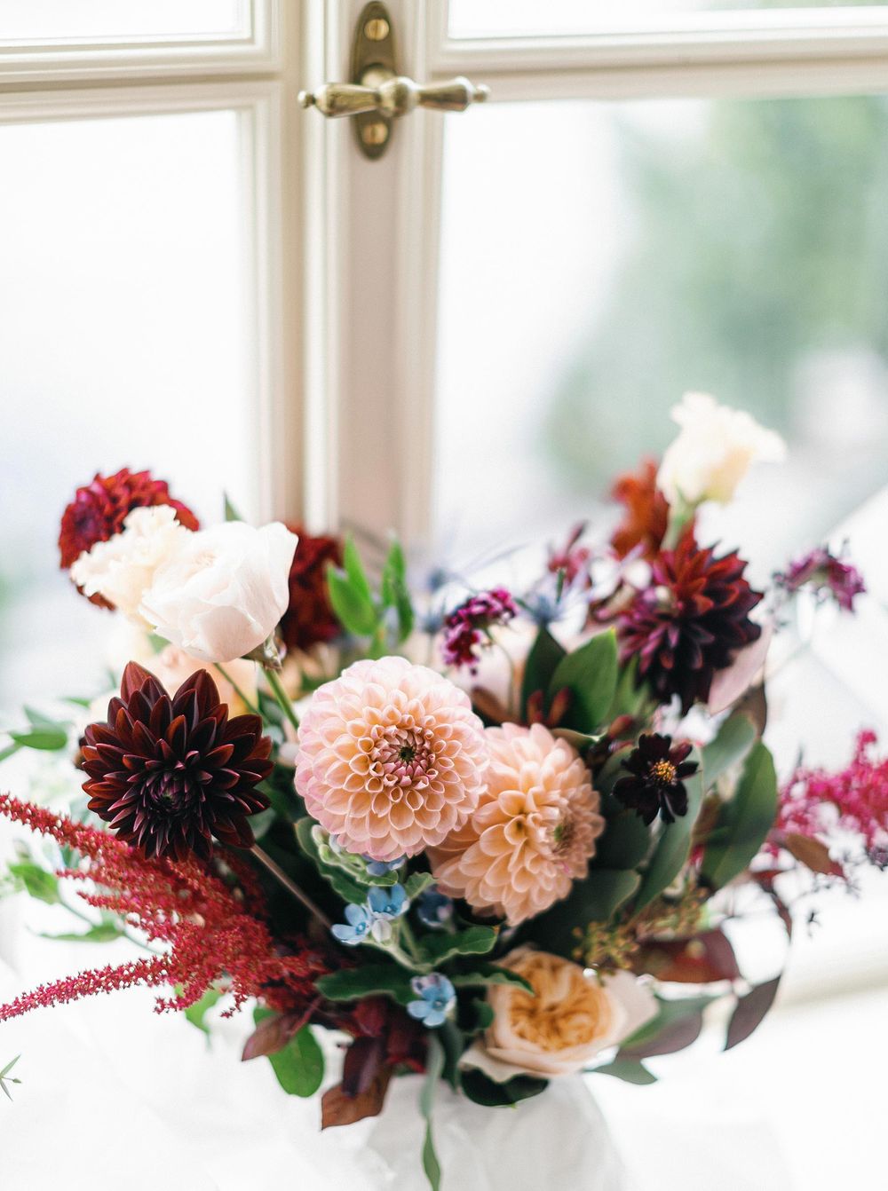 Beautiful wedding bouquet on window ledge.
