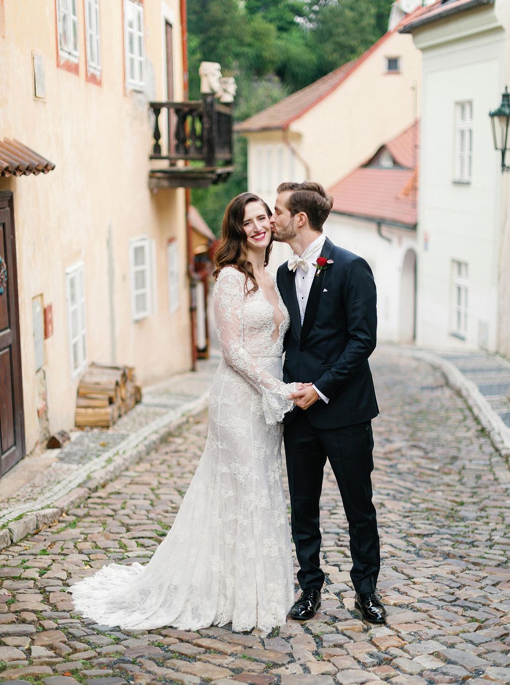 A bride and groom posing in the cobblestone streets of Prague, capturing the essence of their special day.