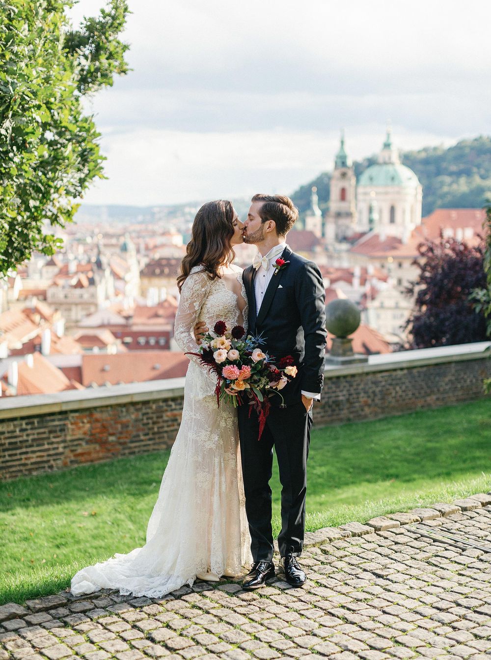 Newlyweds sharing a kiss in Prague.