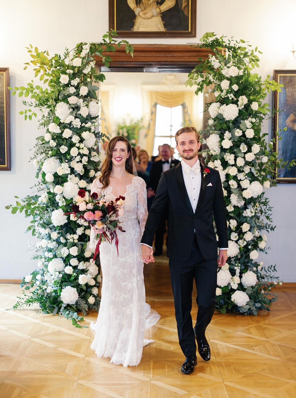 Newlyweds exiting wedding ceremony at Lobkowicz Palace in Prague.