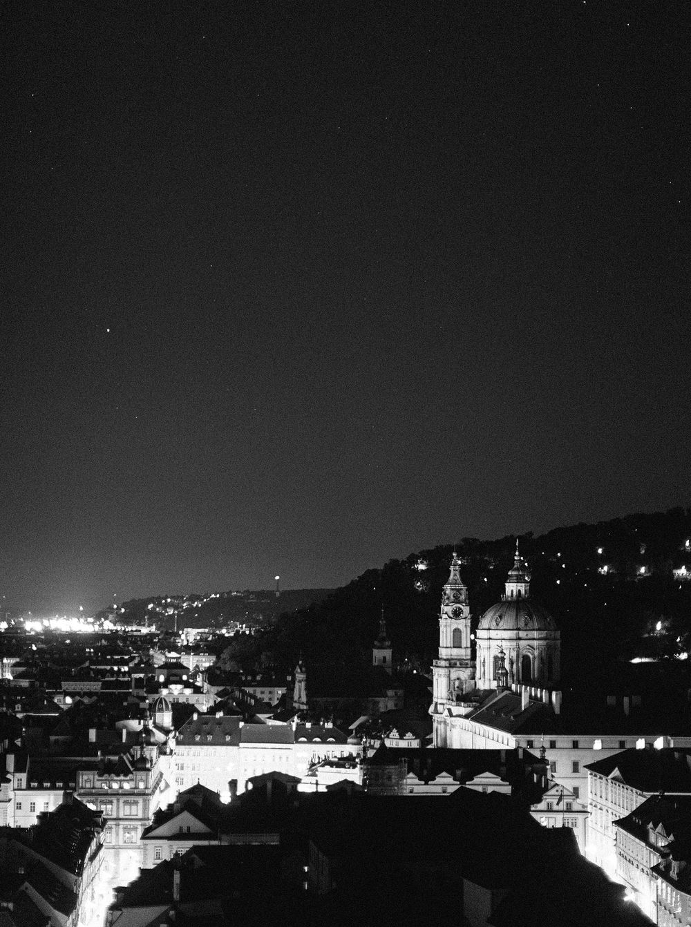 Black and white photo of Mala strana - Prague view from castle at night.