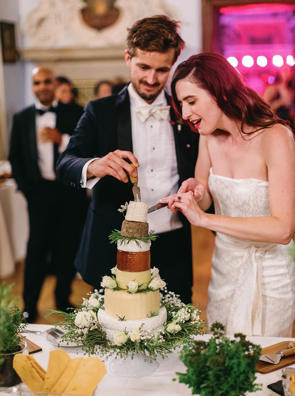 Bride and groom cutting wedding cake at castle in Prague.