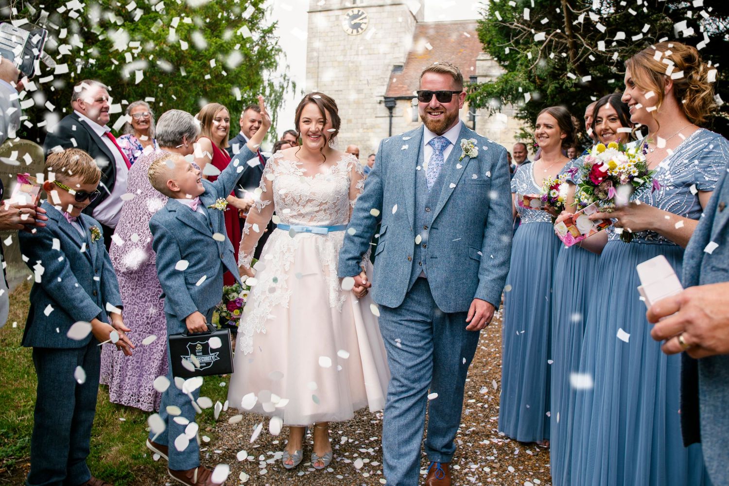 bridge and groom walk through confetti group photo at St Helen's Church Stillingfleet york