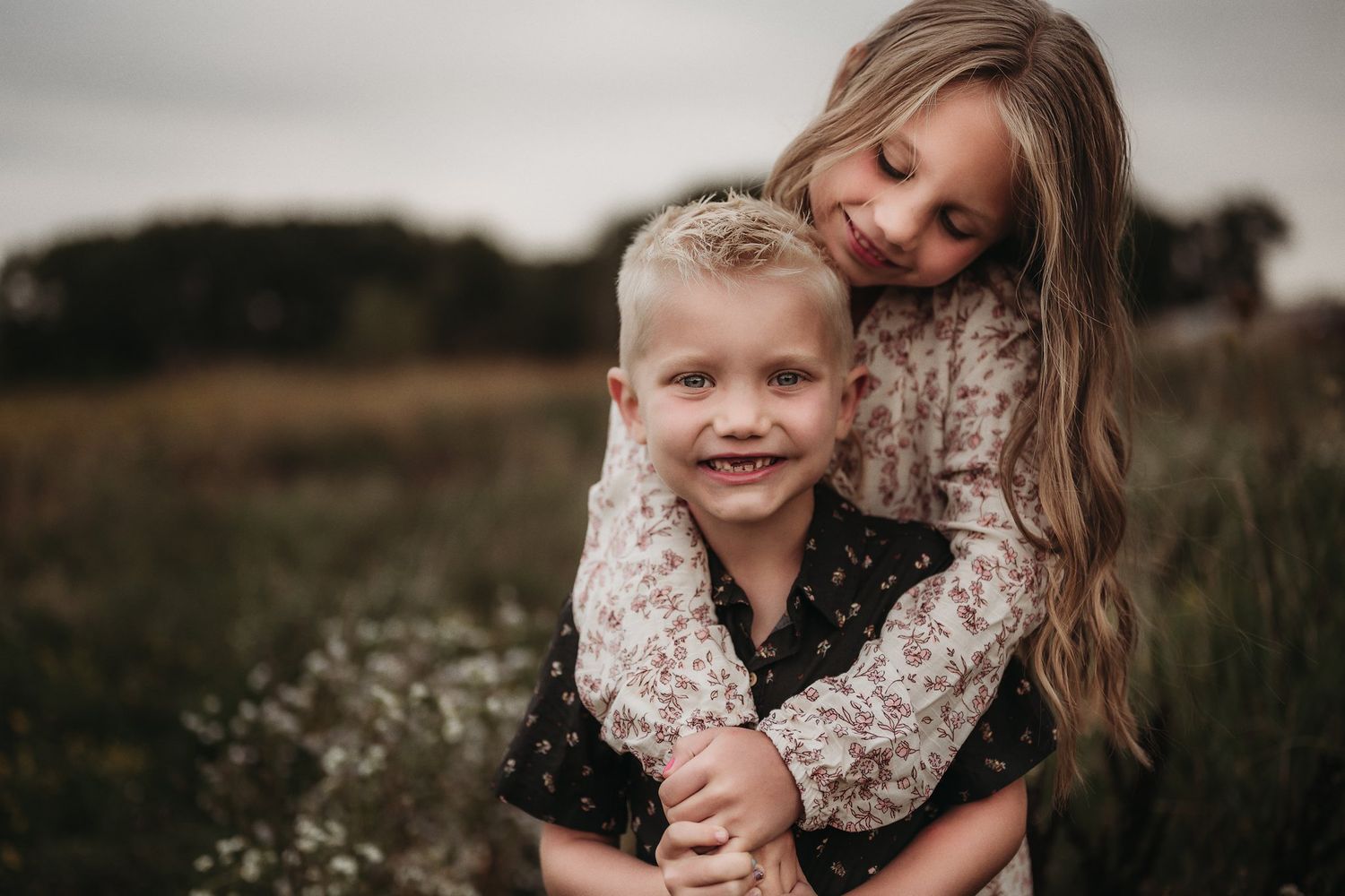 A tender moment shared between two people in a rustic outdoor setting.