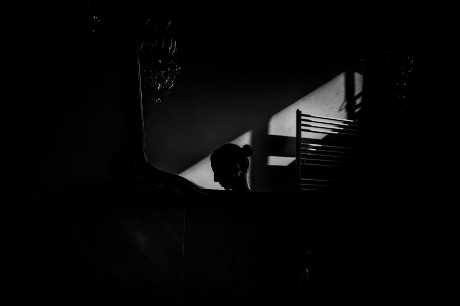 Mysterious noir-style photograph showing shadows on a staircase.