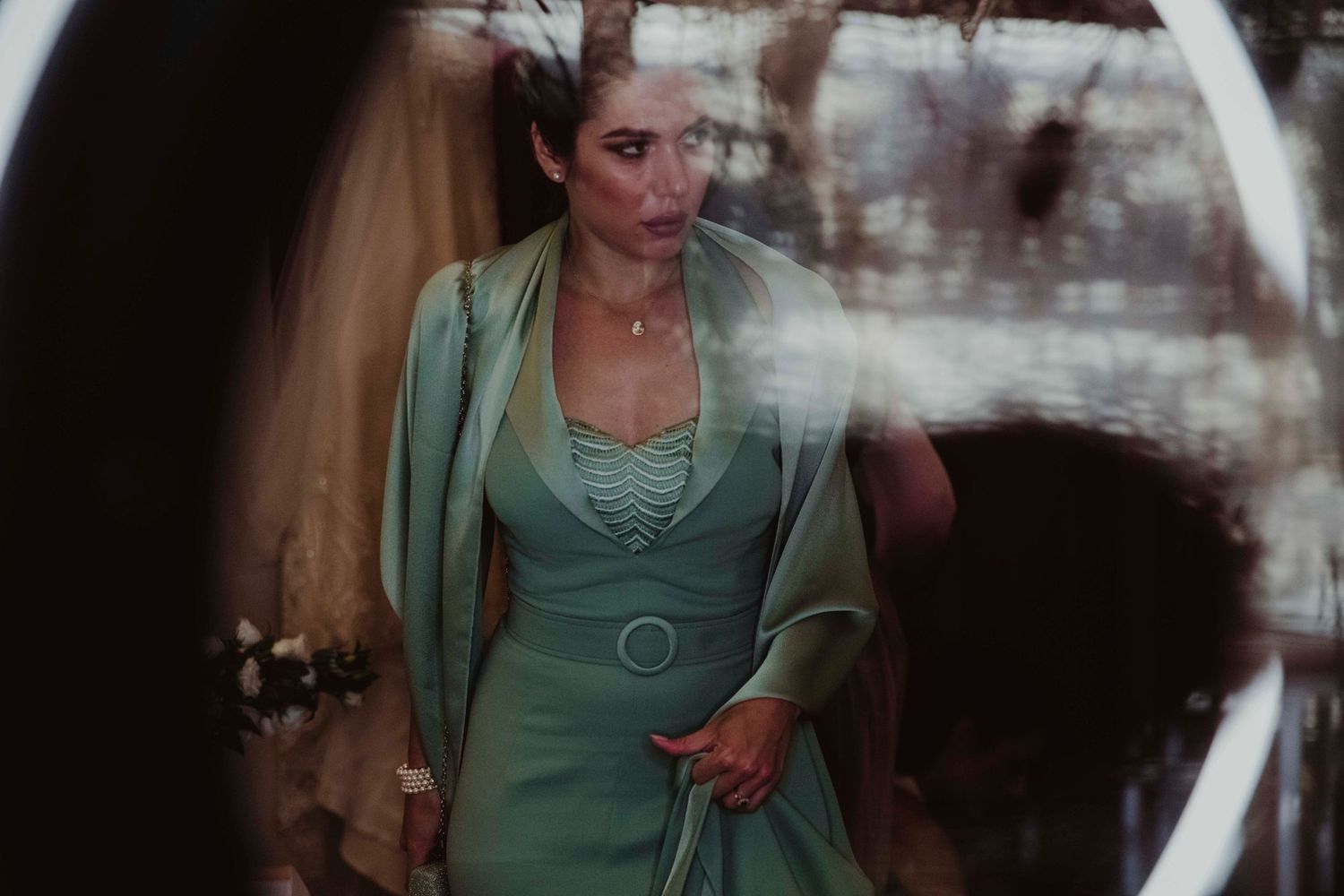 Figure in mint green vintage-style dress photographed through a dreamy, soft focus lens.