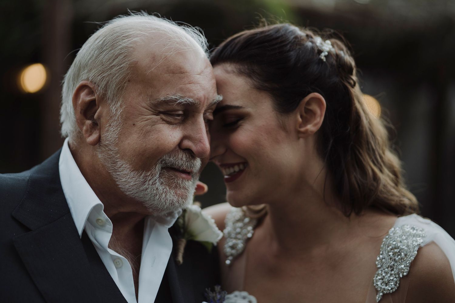 A tender emotional moment shared between two people during a wedding celebration.