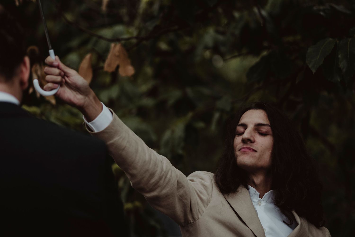 A guest captures a special moment on their phone during an outdoor wedding celebration.
