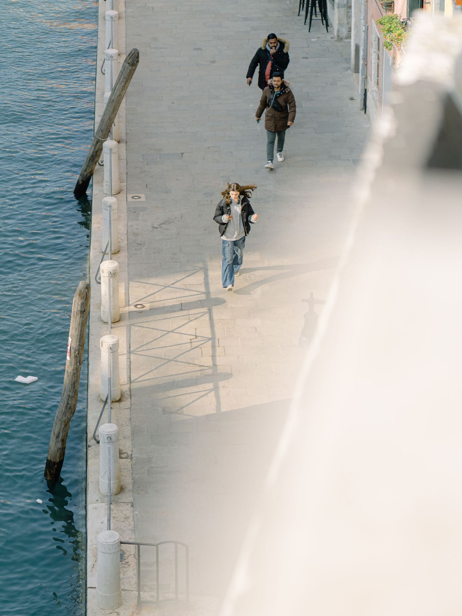 A beautiful young woman walking in the streets of Venice Italy