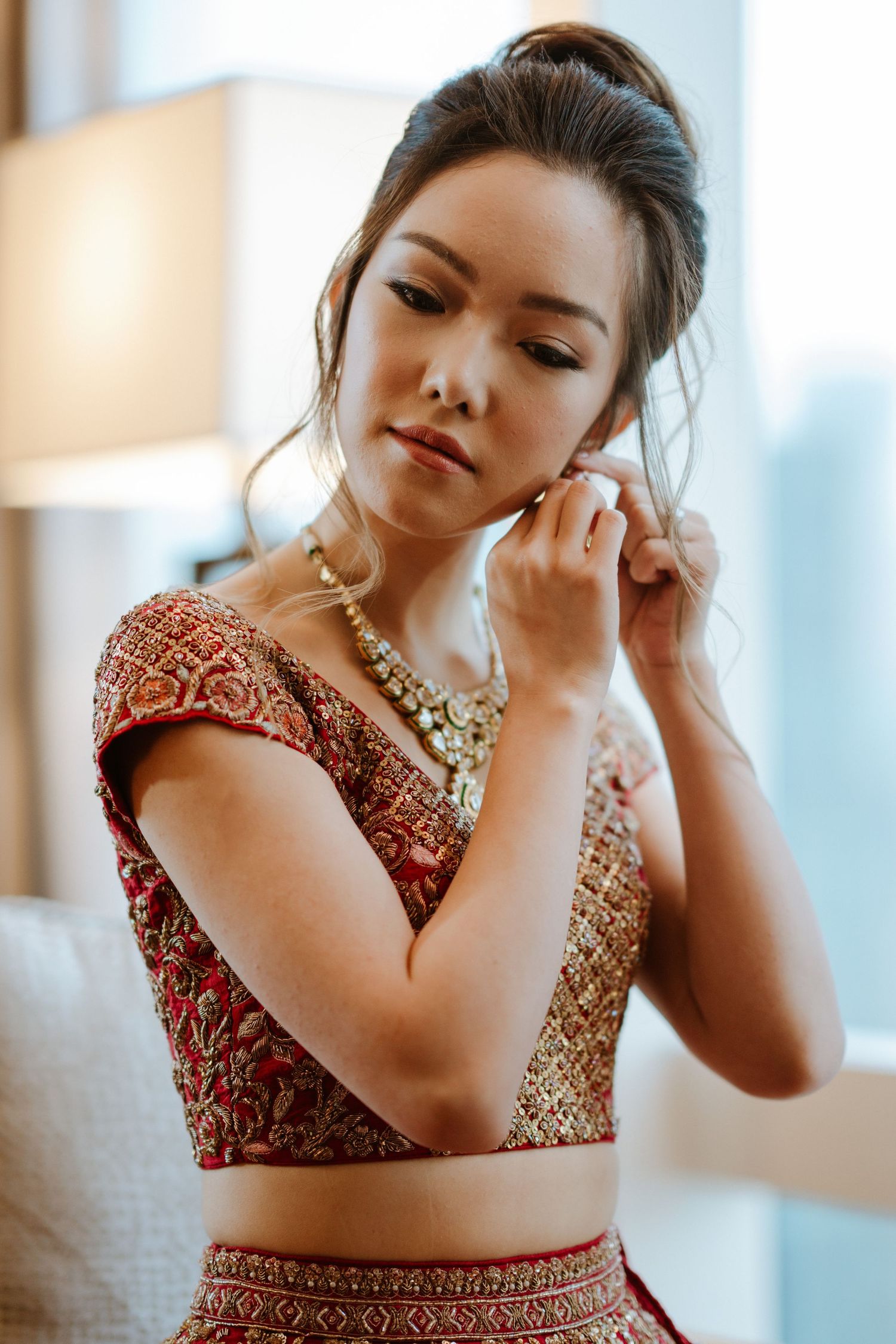 Close-up shots of intricate gold jewelry and embroidered red wedding attire.