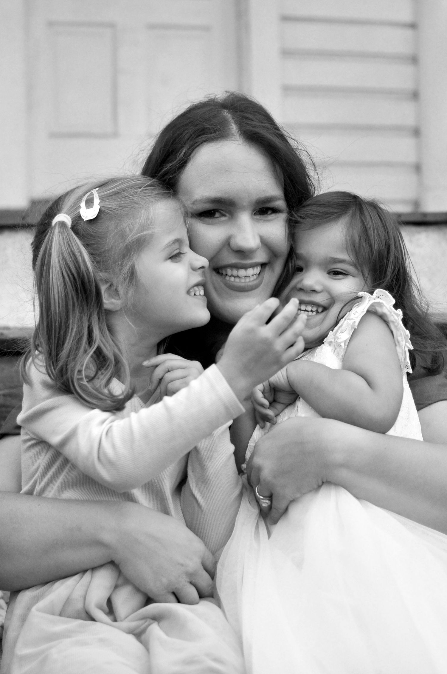Mom with two girls hugging and smiling
