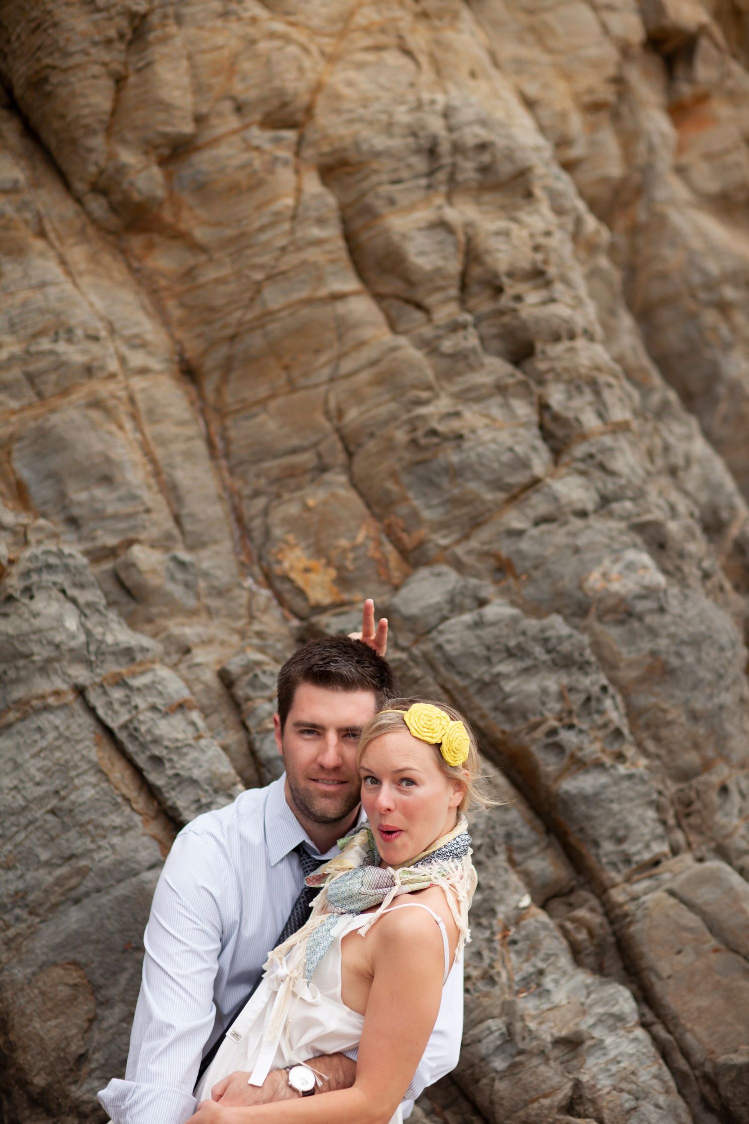 Romantic portraits captured against a dramatic rocky cliff background.