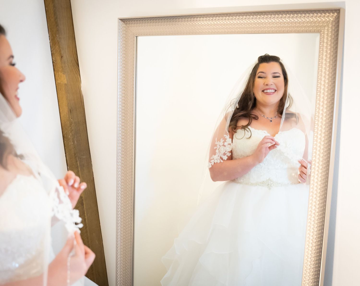 Ethereal bridal portraits against light neutral background showing movement and joy.