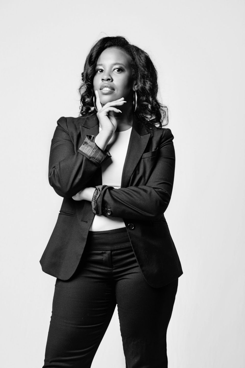 Professional portrait series showing a person in a black blazer posing against a white background.