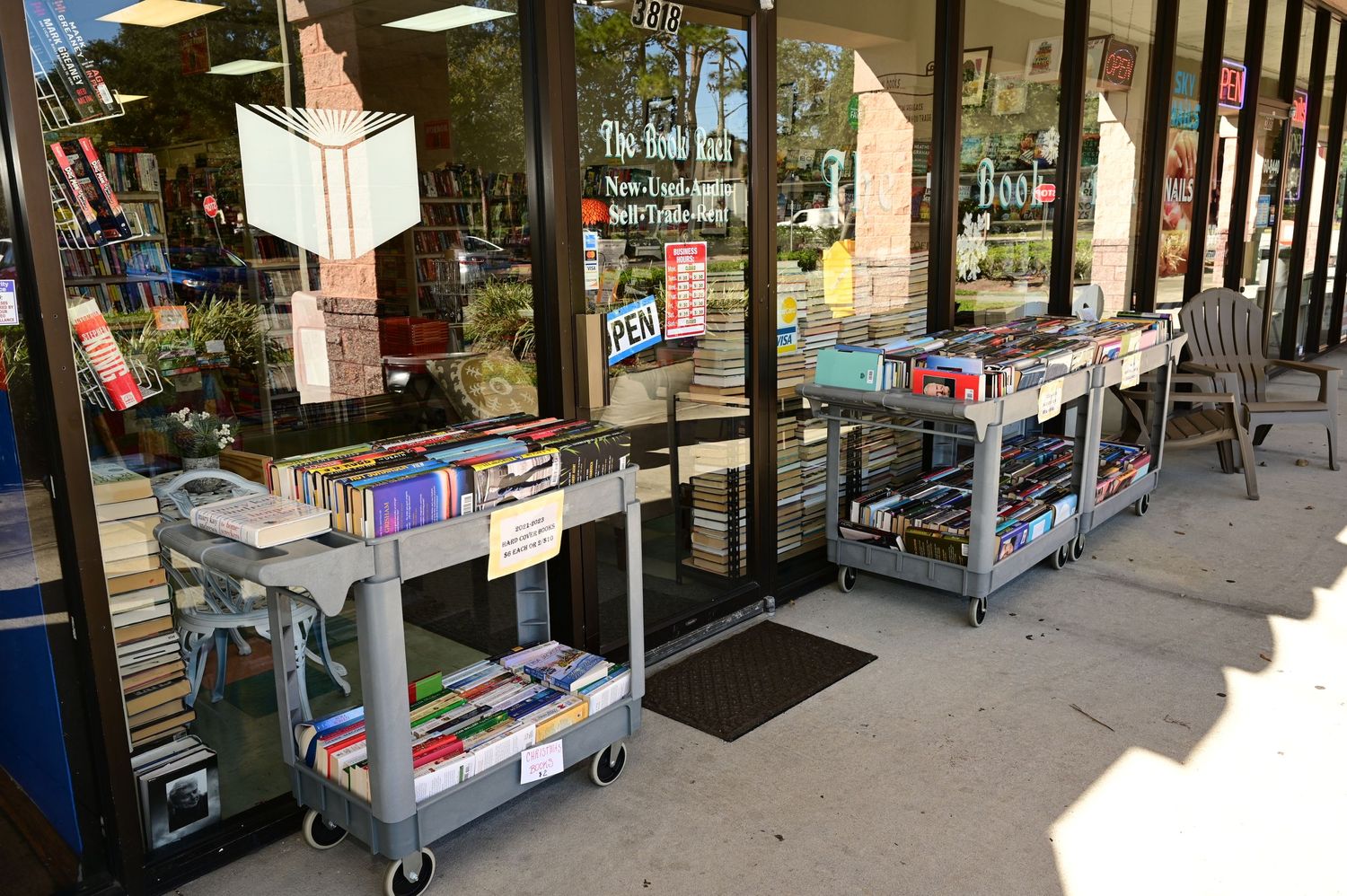 Exterior storefront view of a bookstore with covered walkway and outdoor display cases.
