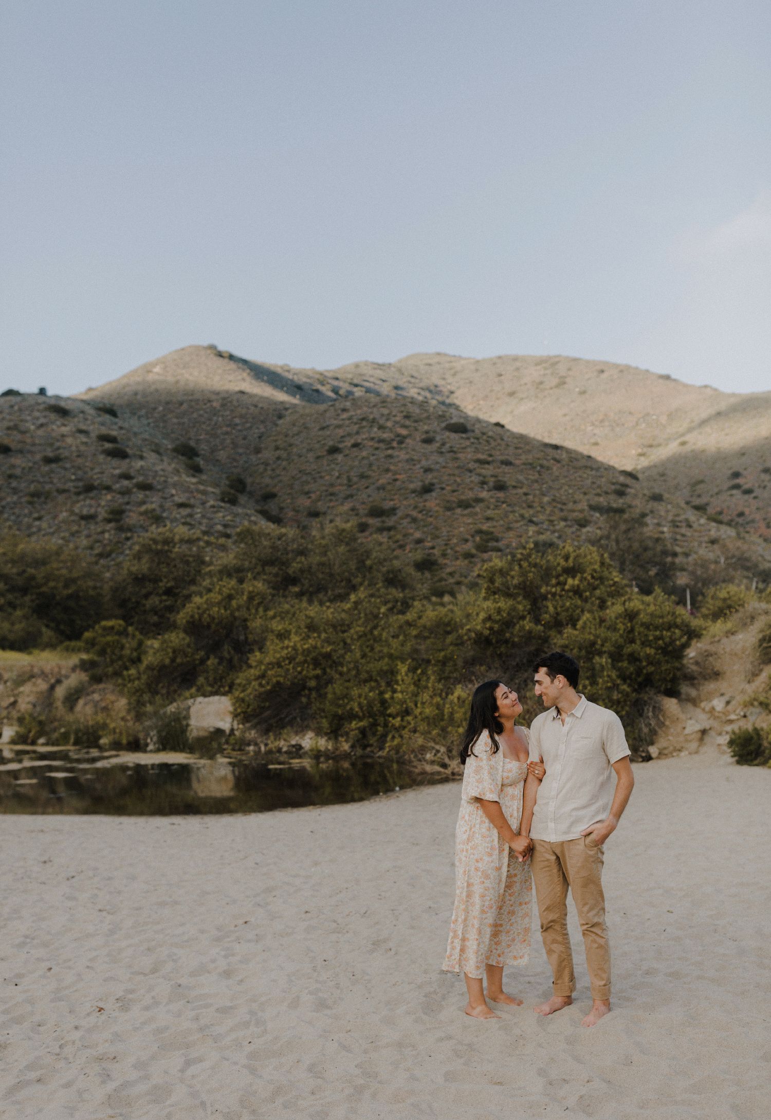E. Noelle Photography couple engagement in the Los Angeles Malibu hills, holding hands in front of mountain landscape