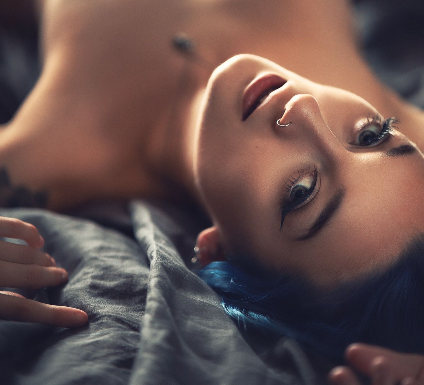 Close-up portrait of a woman with dramatic lighting and soft focus, intimate artistic boudoir photography Southampton