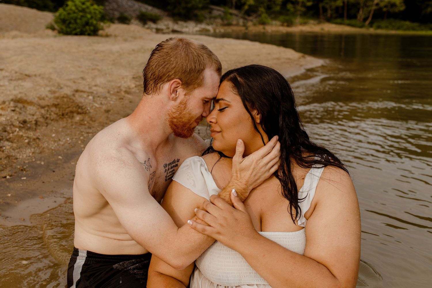 A tender moment shared between a couple by the water.