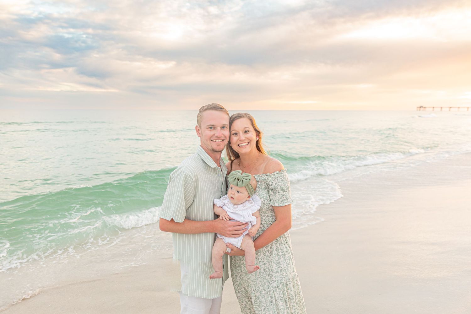 Romantic beach portraits with soft pastel sunset colors and gentle ocean waves.
