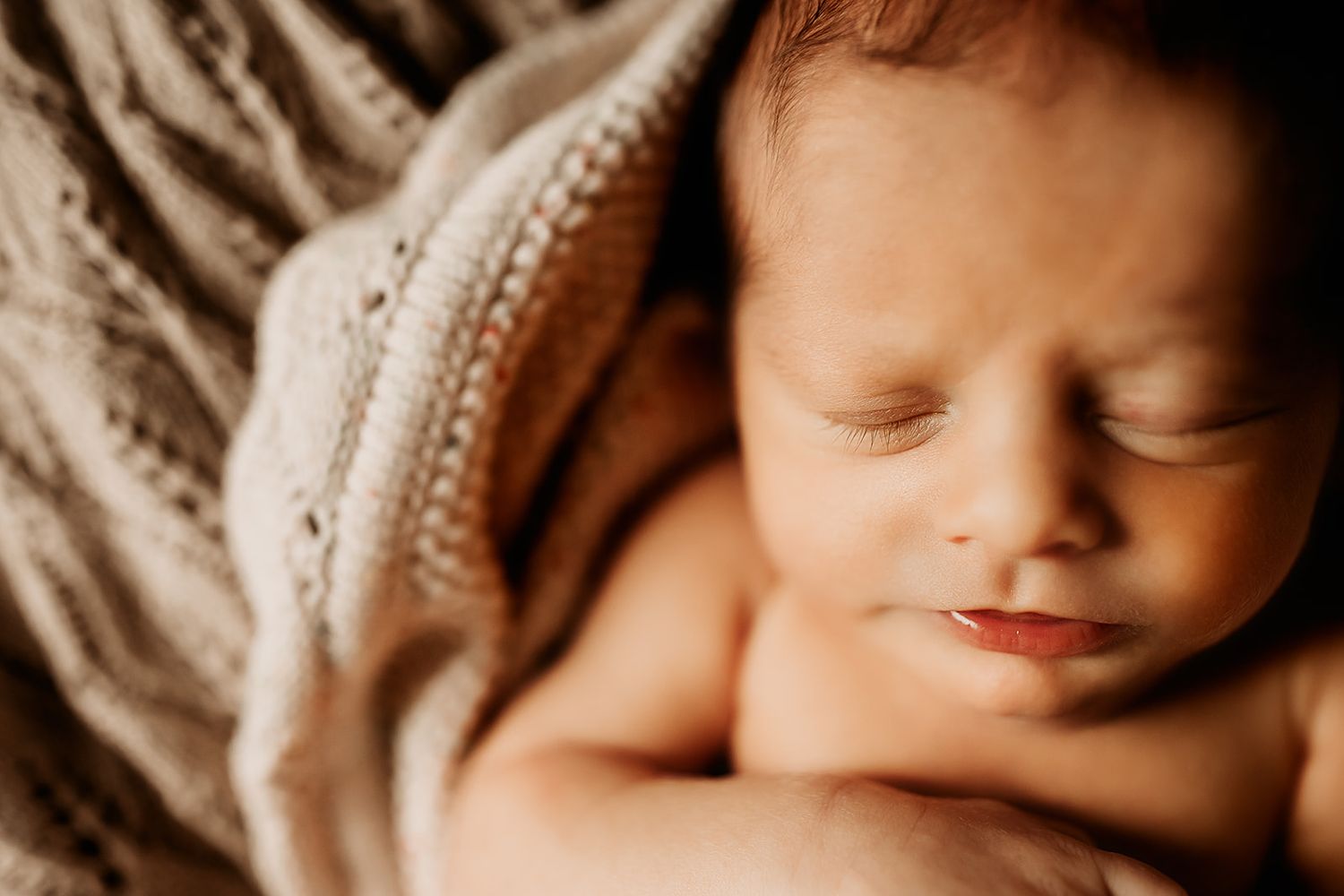 A zoomed in shot of a newborn boy's eyelashes.