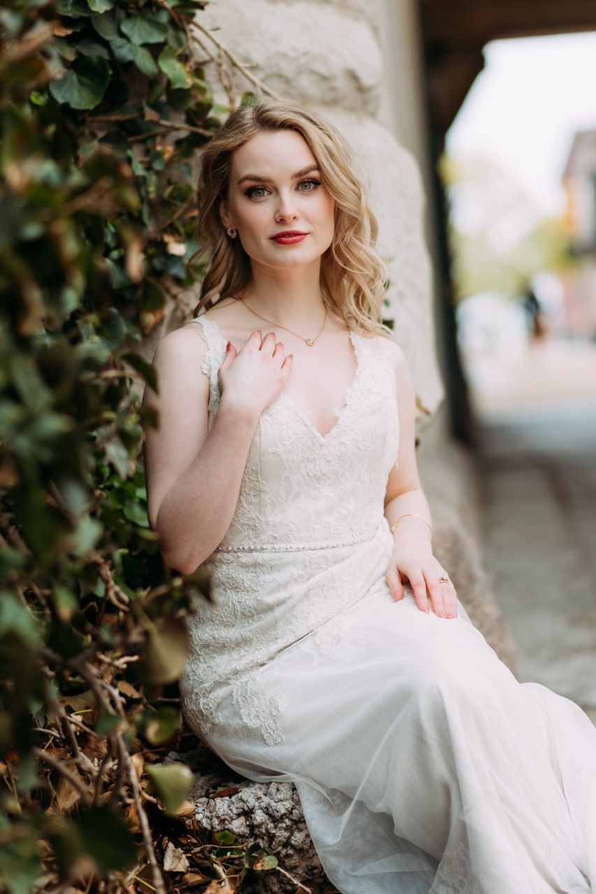 Bride posing next to a stone wall covered in ivy at Union Station hotel in St. Louis Missouri