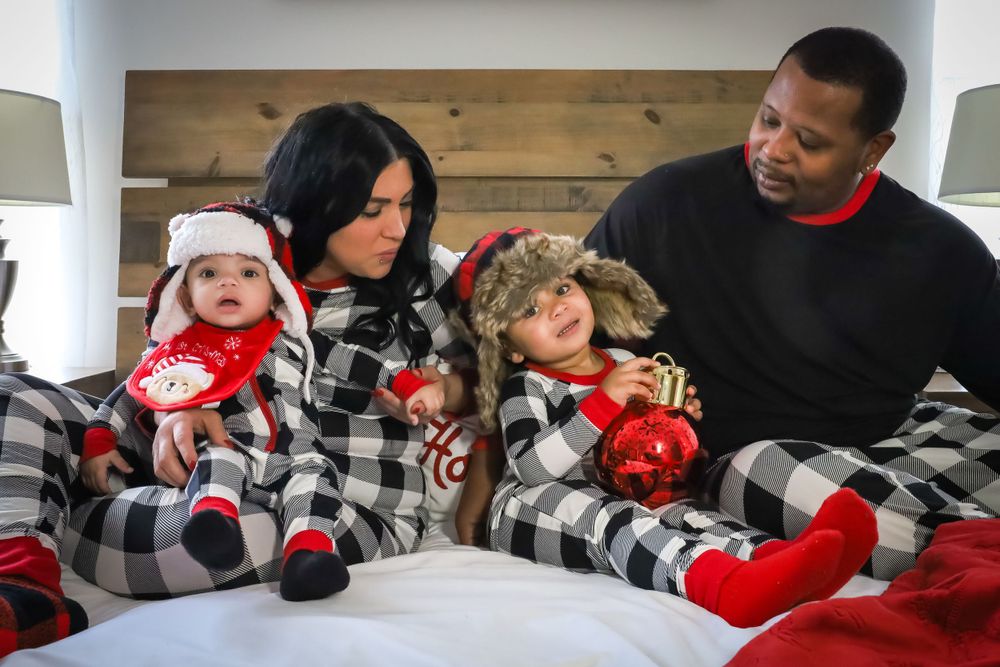 A group wearing matching buffalo plaid and red scarves in winter attire.