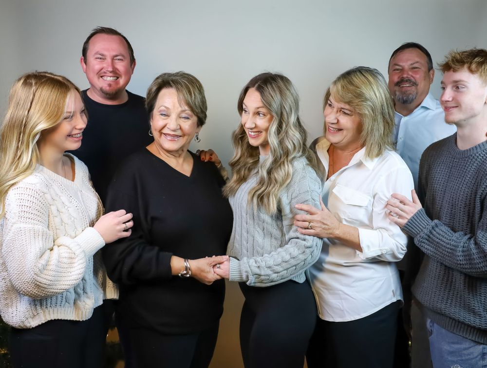 A group photo of family members posing together in casual attire.