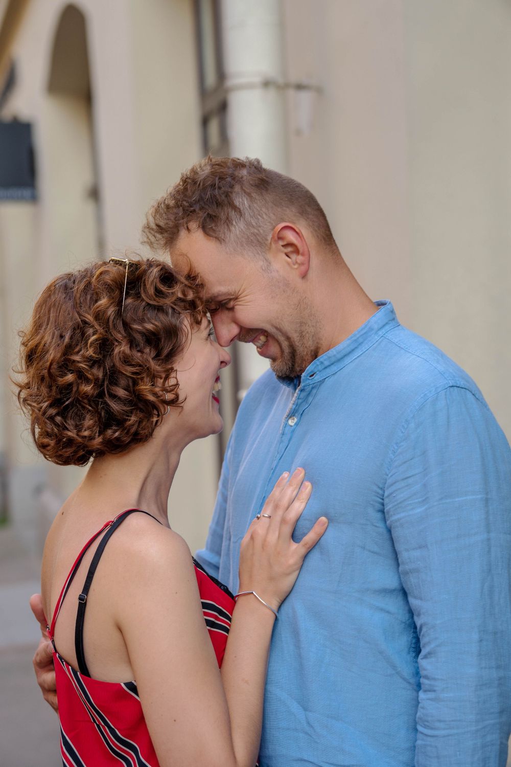 A woman and a man stand close to each other.