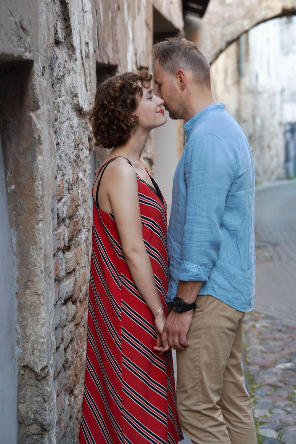 A woman and a man stand close to each other.