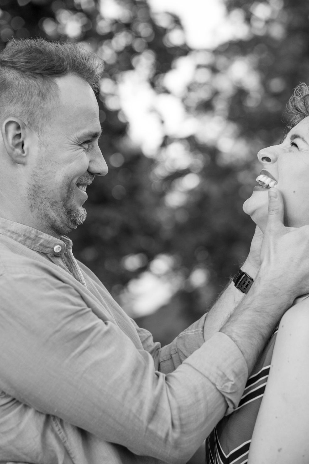 A man is holding a woman and smiles.